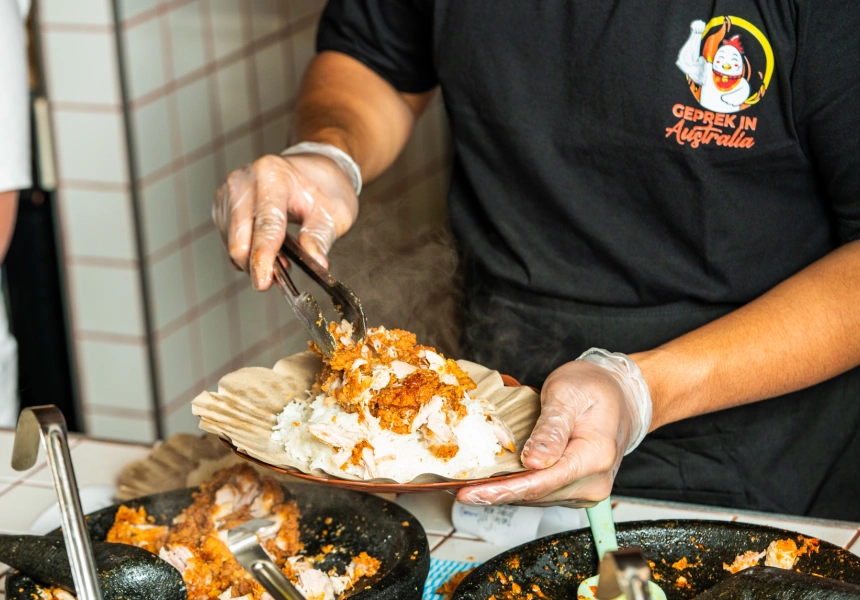 Chef plating a Geprek dish
